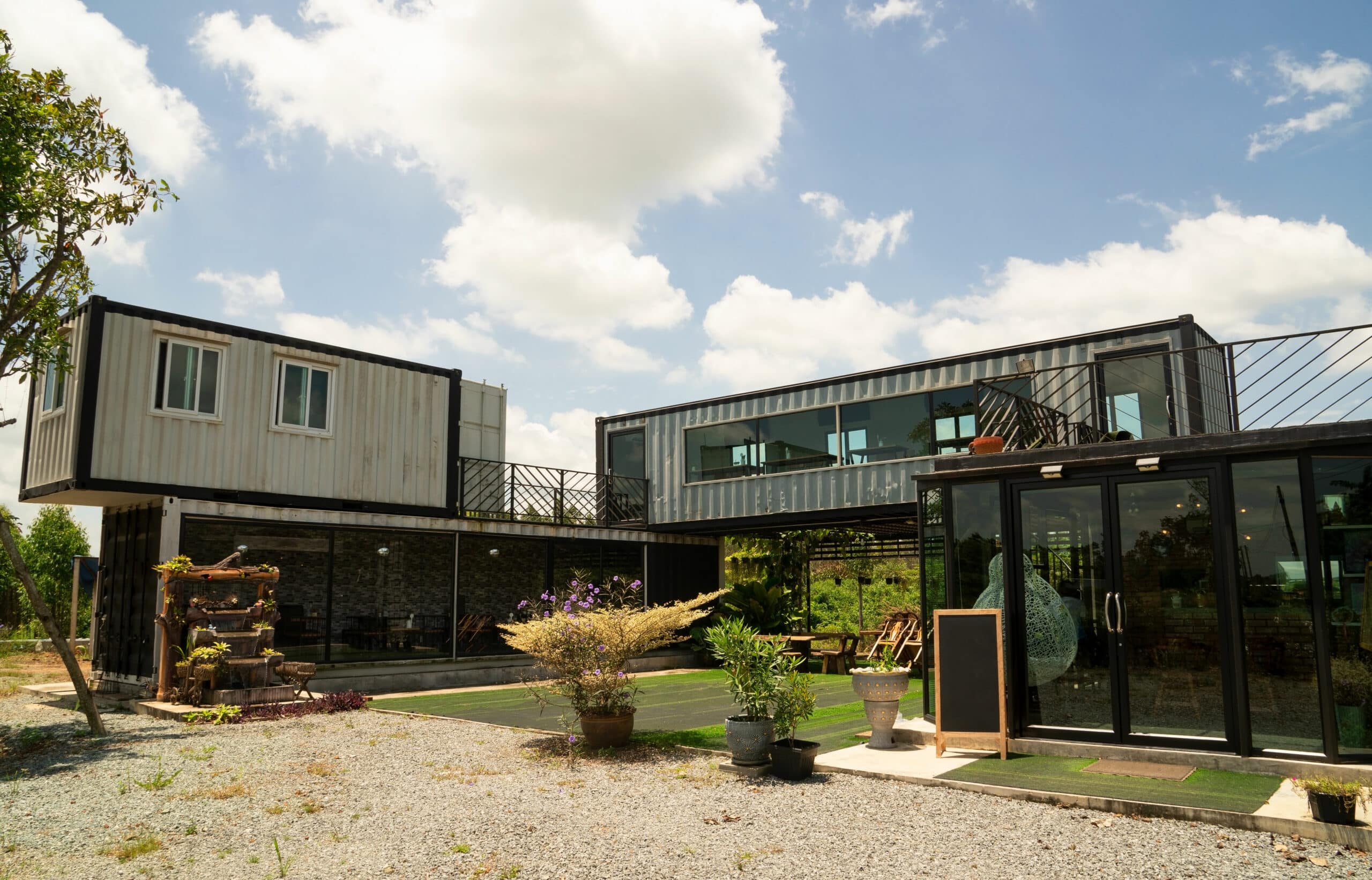 Modern metal building made from shipping house containers and blue sky background .